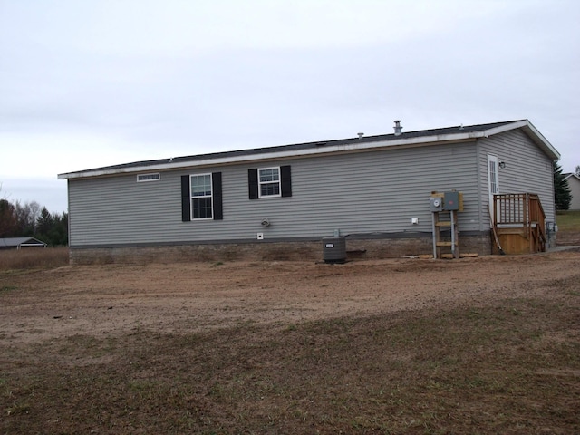 back of property with central AC