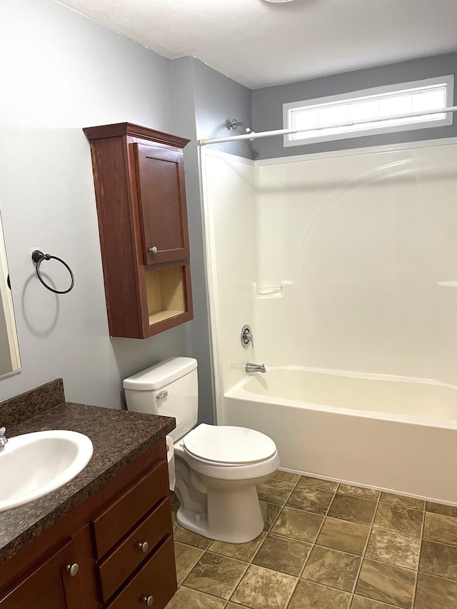 bathroom with toilet, vanity, and bathtub / shower combination