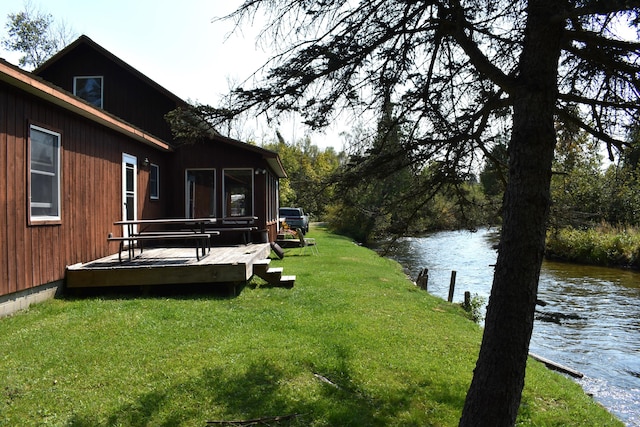 view of yard featuring a deck with water view