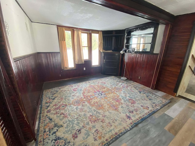 foyer featuring wooden walls, a healthy amount of sunlight, and a wainscoted wall