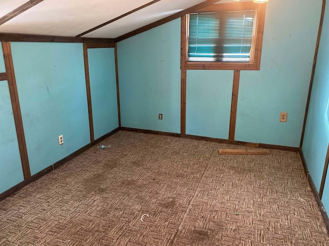 interior space with baseboards and lofted ceiling