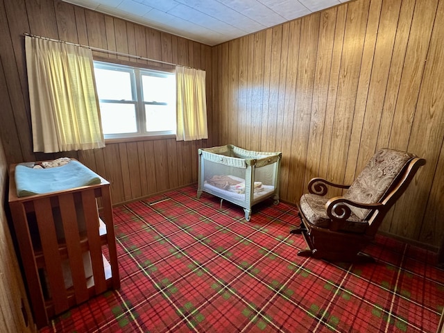 bedroom featuring wooden walls