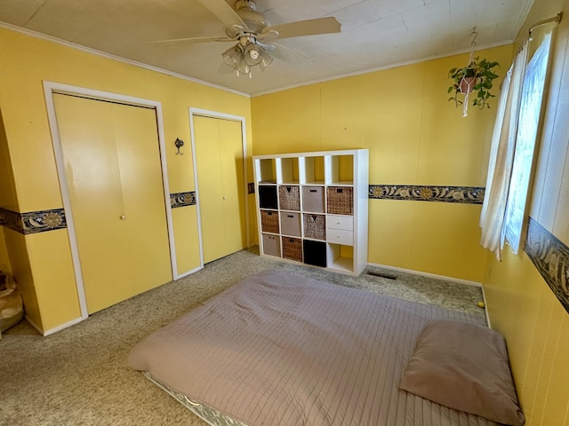 unfurnished bedroom with ceiling fan, carpet flooring, and ornamental molding