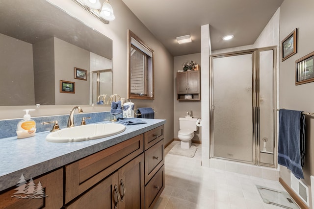 full bathroom with a shower stall, toilet, vanity, and baseboards