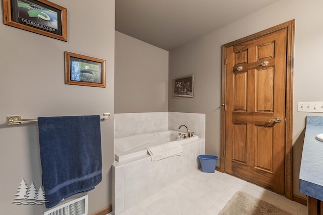 full bathroom with tile patterned flooring, a garden tub, and visible vents