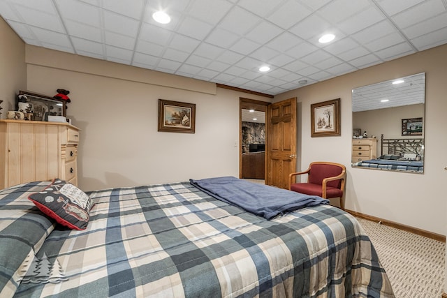 carpeted bedroom with a drop ceiling, recessed lighting, and baseboards