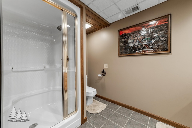 full bathroom featuring baseboards, visible vents, a shower stall, a paneled ceiling, and tile patterned floors