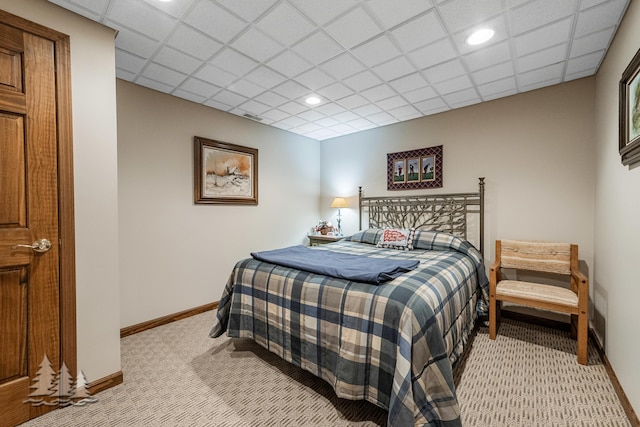 bedroom with recessed lighting, a paneled ceiling, baseboards, and light carpet