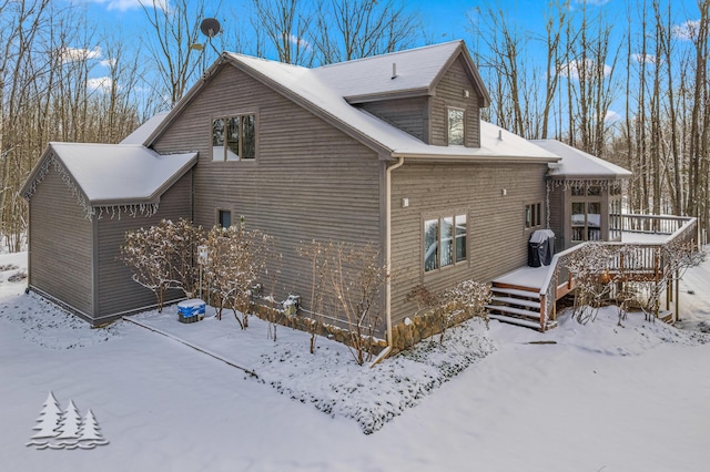 snow covered property featuring a deck