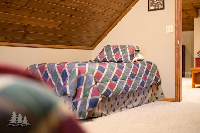 bedroom with wooden ceiling, carpet flooring, baseboards, and lofted ceiling