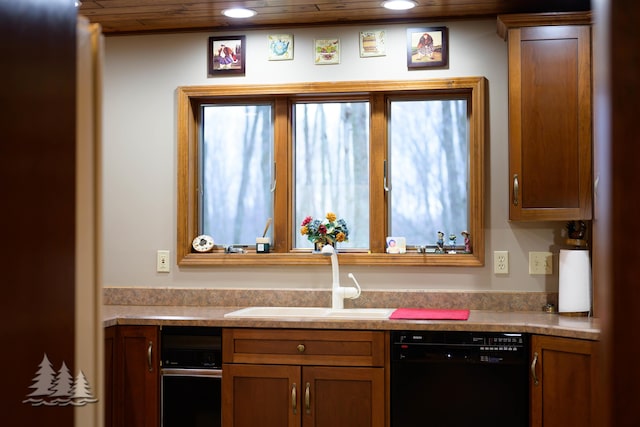 kitchen with brown cabinetry, recessed lighting, a sink, light countertops, and black dishwasher