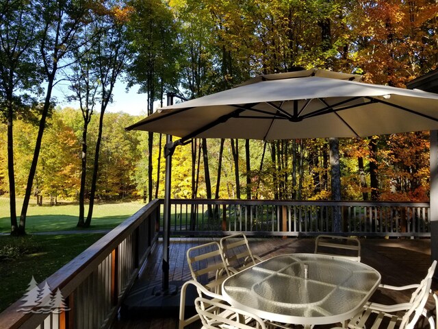 wooden terrace featuring outdoor dining space