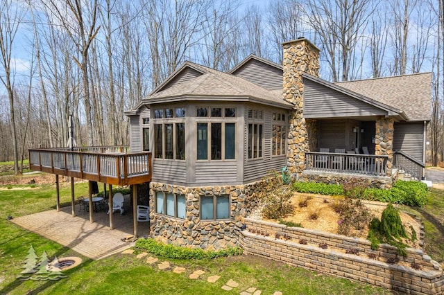 220 Skyview Ct, Lewiston, MI 49756 - rear view of property featuring a chimney, stone siding, and roof with shingles