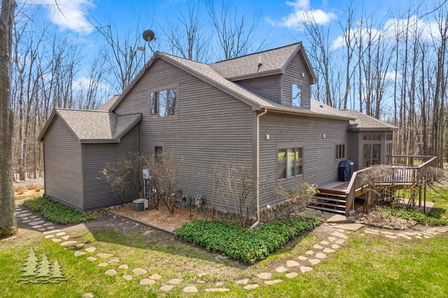 220 Skyview Ct, Lewiston, MI 49756 - view of home's exterior featuring a deck and roof with shingles