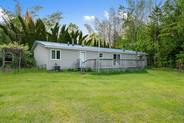 6626 Varonica Ln, Cheboygan, MI 49721 - rear view of house with a lawn, a deck, and metal roof