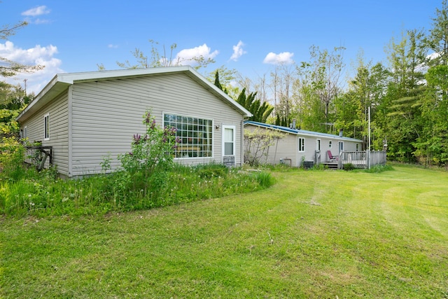 6626 Varonica Ln, Cheboygan, MI 49721 - rear view of house with a yard and a wooden deck