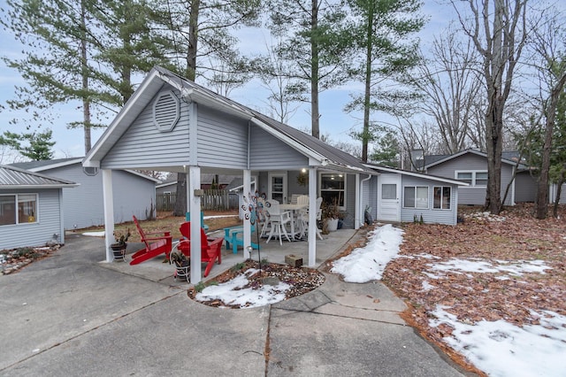 rear view of house featuring driveway, a patio, and fence