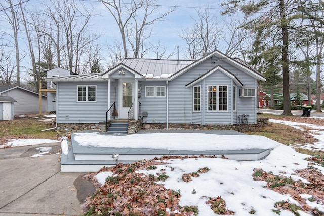 bungalow-style home with metal roof and a standing seam roof