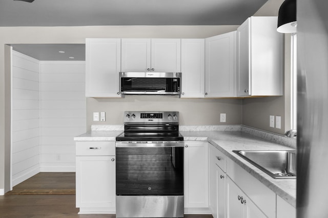 kitchen with white cabinetry, light countertops, and appliances with stainless steel finishes