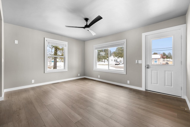 interior space with dark wood finished floors, visible vents, baseboards, and ceiling fan