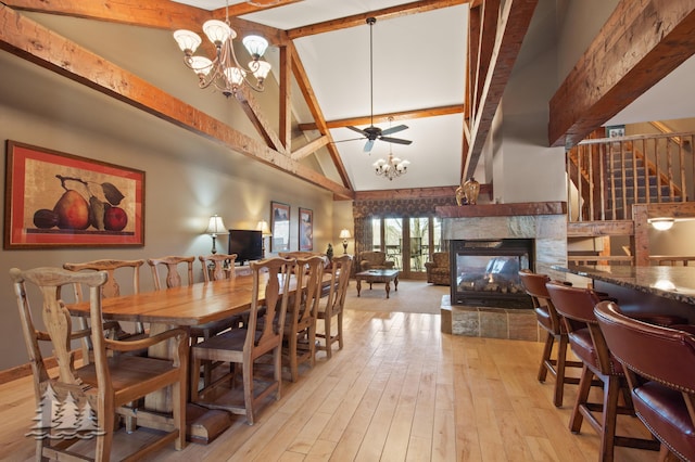 dining space featuring beamed ceiling, high vaulted ceiling, stairway, light wood finished floors, and a multi sided fireplace