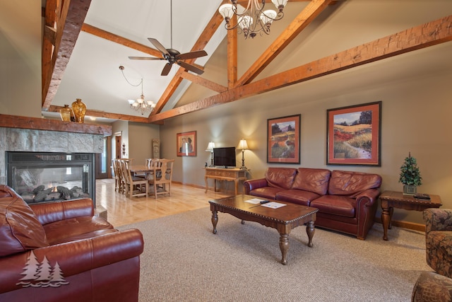 living room with beamed ceiling, ceiling fan with notable chandelier, a multi sided fireplace, and high vaulted ceiling