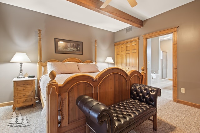 bedroom featuring visible vents, baseboards, carpet, beam ceiling, and a closet