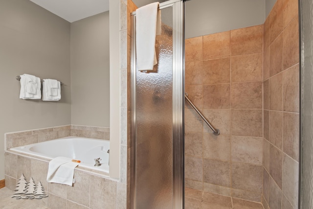 bathroom featuring a stall shower and a bath