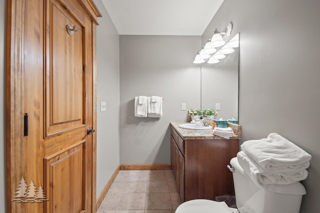 bathroom featuring tile patterned floors, toilet, vanity, and baseboards