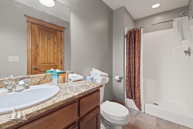 full bath featuring vanity, a shower stall, and toilet