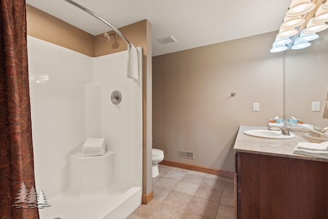 bathroom featuring visible vents, a shower stall, toilet, and a sink