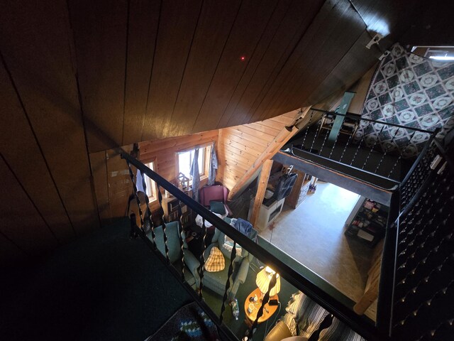 staircase featuring wood walls and wooden ceiling