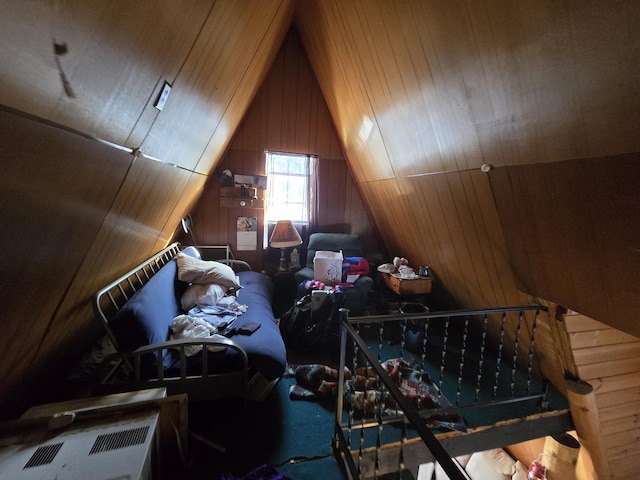 bedroom featuring lofted ceiling and wooden walls