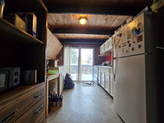 kitchen with stone finish flooring, electric range oven, beam ceiling, wooden ceiling, and freestanding refrigerator