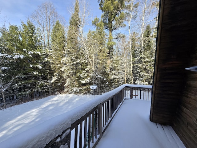 view of snow covered back of property