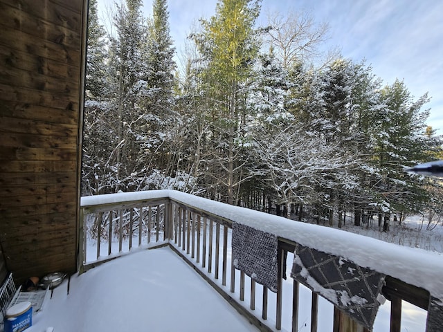 view of snow covered back of property