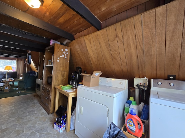 washroom with wooden walls, washing machine and dryer, wood ceiling, and laundry area