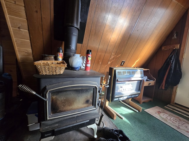 room details featuring carpet flooring, wooden walls, and a wood stove