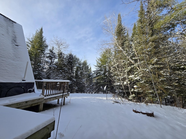 yard layered in snow with a deck