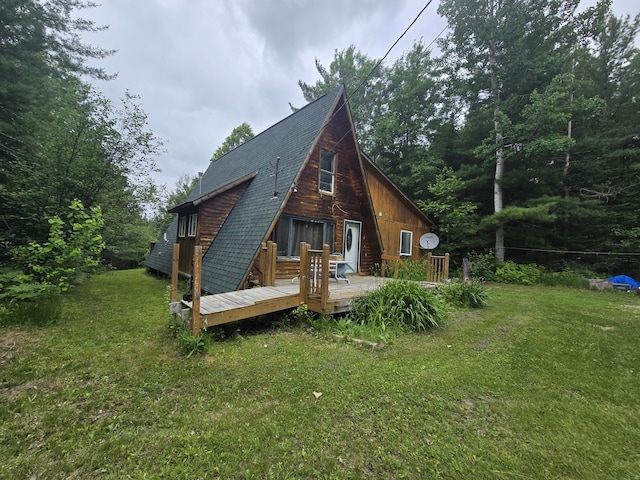 2709 Timberlane Trl, Grayling, MI 49738 - back of property with a lawn, a wooden deck, and roof with shingles