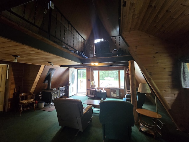 2709 Timberlane Trl, Grayling, MI 49738 - living room with a wood stove, wood walls, high vaulted ceiling, carpet, and wooden ceiling