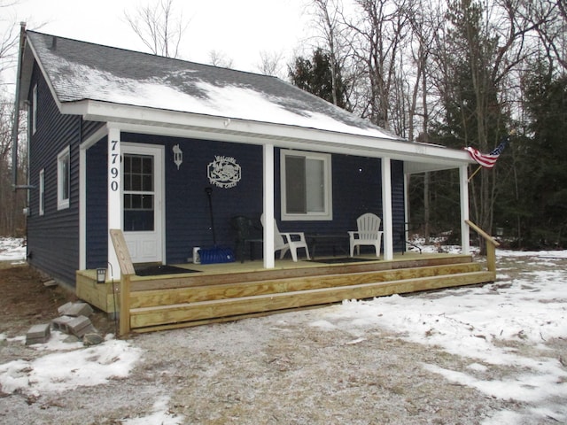 view of front of house featuring a porch and roof with shingles