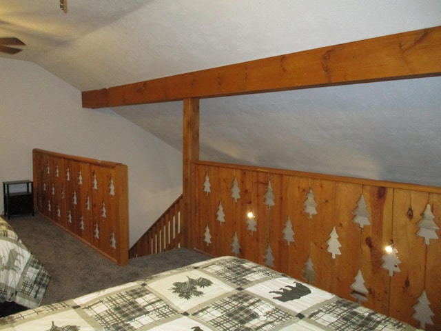 interior space with wood walls and vaulted ceiling with beams