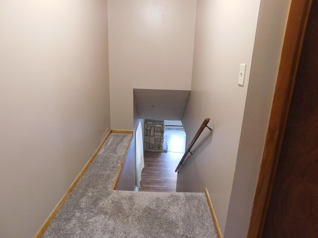 staircase featuring baseboards