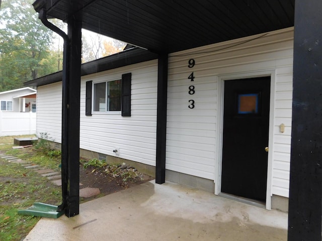 entrance to property featuring fence