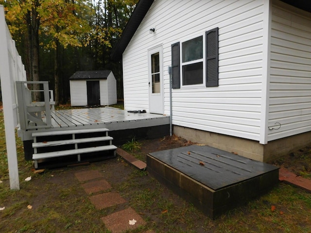 deck featuring an outdoor structure and a shed