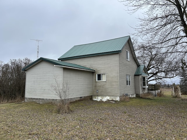 view of property exterior with crawl space and metal roof