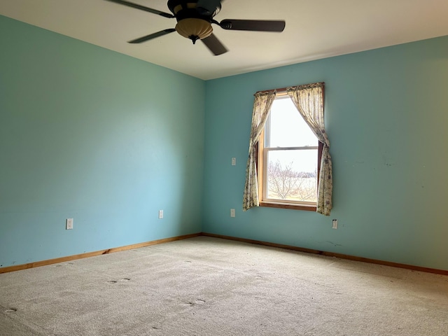 unfurnished room featuring a ceiling fan, baseboards, and carpet floors