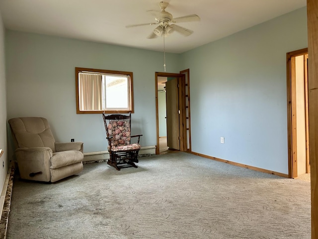 living area with a baseboard heating unit, baseboards, ceiling fan, and carpet flooring