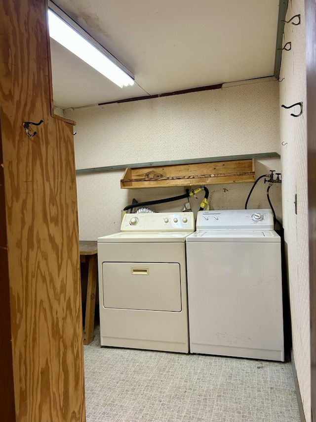 clothes washing area featuring washing machine and dryer and laundry area